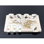 A fine Japanese ivory Bezique counter, Meiji period, superbly inlaid with birds and insects,