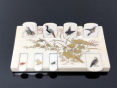 A fine Japanese ivory Bezique counter, Meiji period, superbly inlaid with birds and insects,