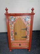 A 20th century hand painted wall mounted marriage cabinet