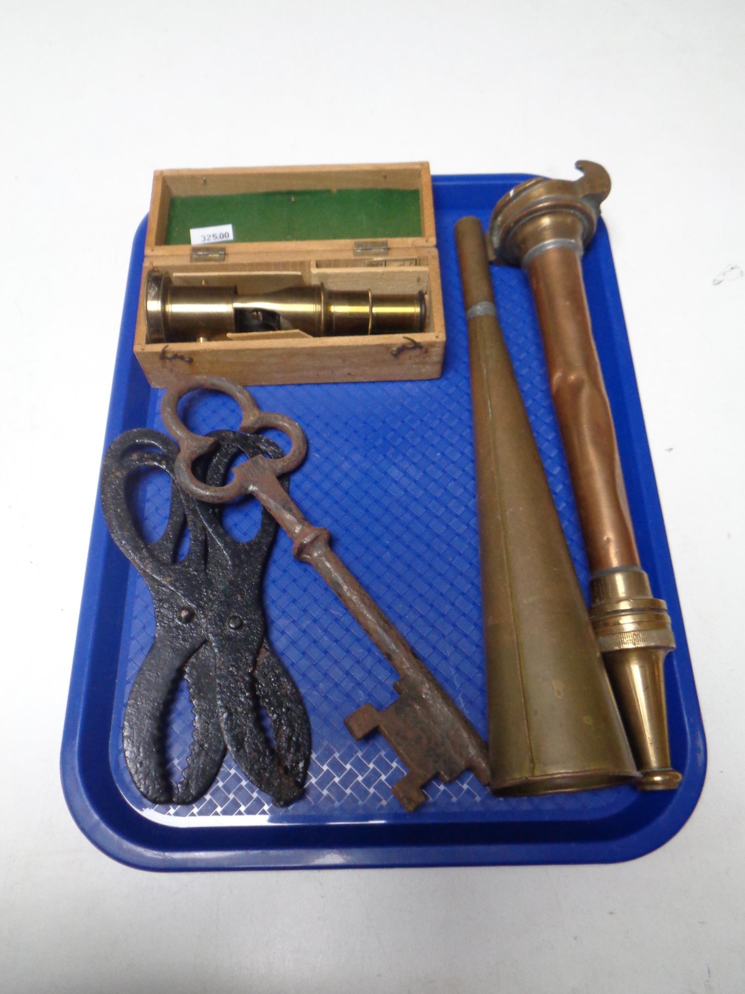 A tray containing an antique copper and brass fire hose nozzle, a copper horn (boxed),