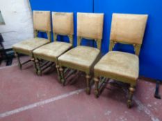 A set of four early 20th century green and gilt dining chairs upholstered in a gold dralon