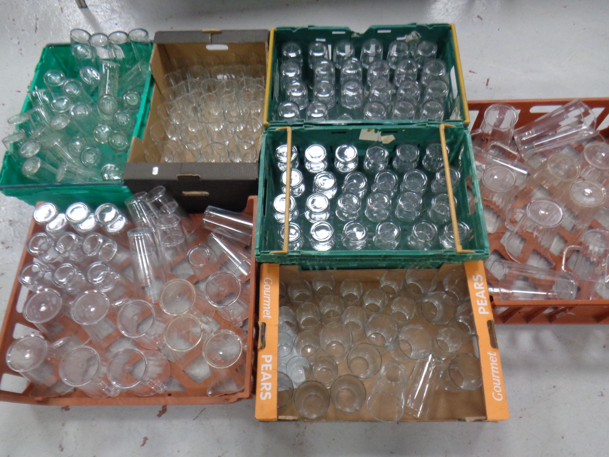 Seven boxes and crates containing assorted pub glasses and plastic water jugs