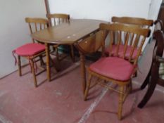 A rubber wood drop leaf kitchen table together with four chairs