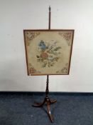 A Victorian tapestry pole screen