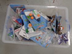 A storage crate with lid containing miscellaneous Christmas and baby toys