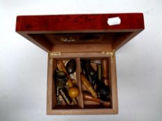 A humidor containing miscellaneous to include bullet bottle opener, cigar cutters,