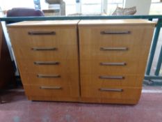 A pair of 20th century teak effect five drawer chests