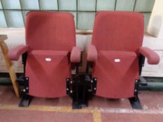 A pair of cinema seats upholstered in a red fabric