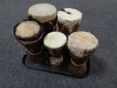 A tray containing six tourist tribal drums