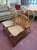 A set of three Ercol solid elm and beech rail back dining chairs together with a further Ercol