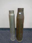 A brass ammunition shell casing together with one other