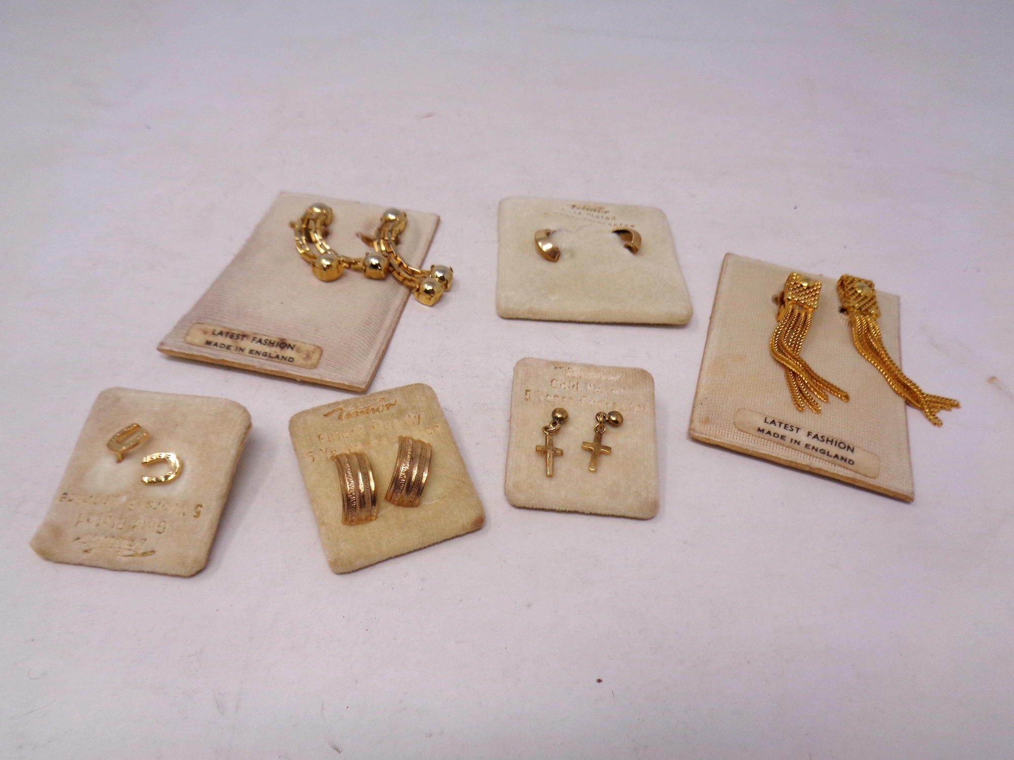 Six pairs of gold plated earrings, horse shoes,