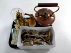 A tray containing an antique copper kettle, assorted plated cutlery,