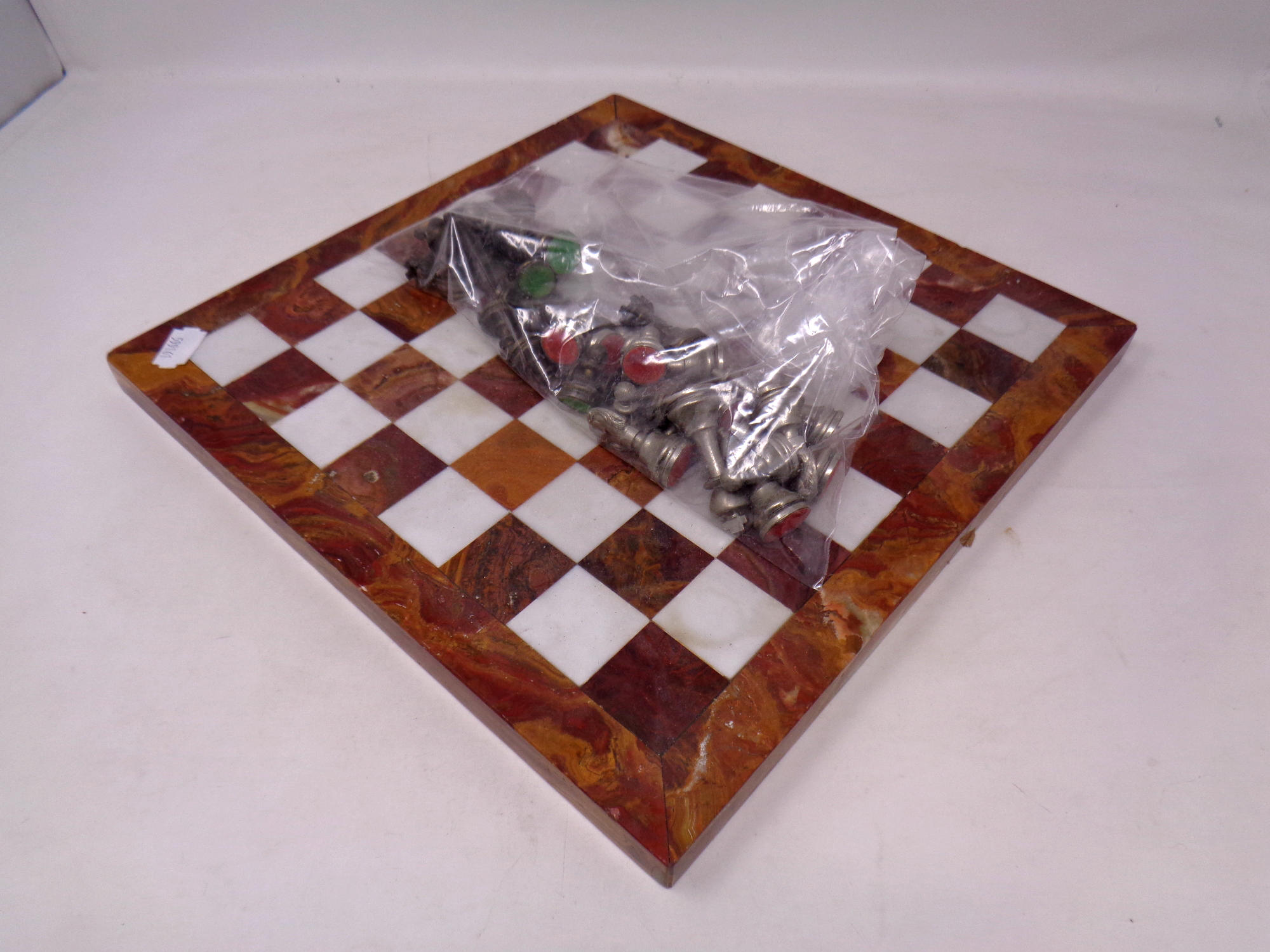 A marble chess board with metal pieces