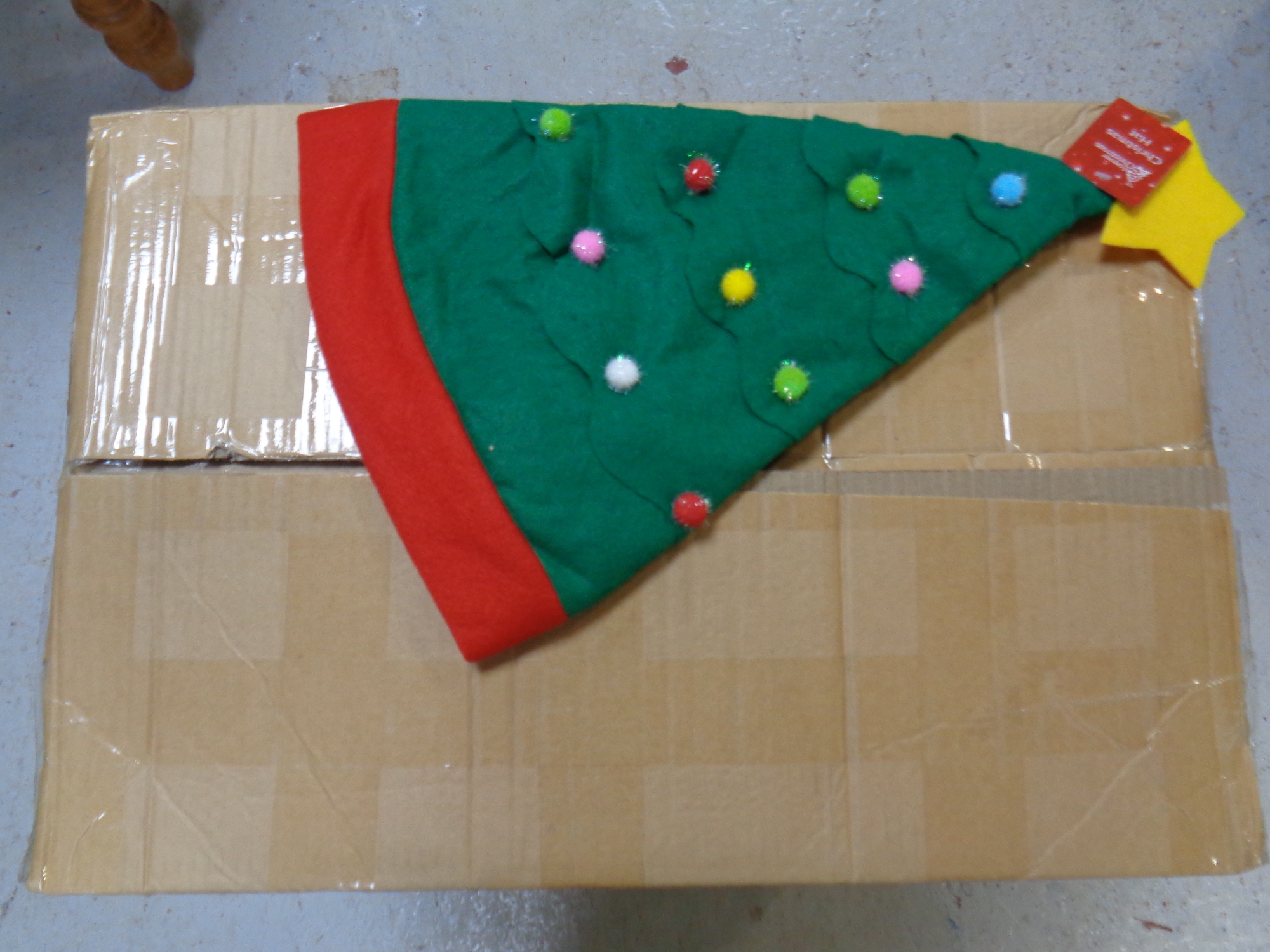 A box containing a quantity of Christmas tree hats