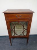 An Edwardian inlaid mahogany display cabinet with later Chanel decoration
