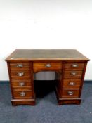 A 19th century walnut twin pedestal desk fitted nine drawers with a leather inset panel