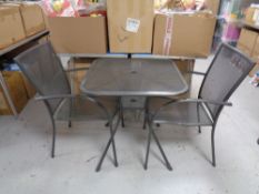 A metal patio table together with pair of armchairs