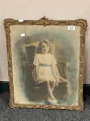 An early twentieth century monochrome photographic print in ornate gilt frame depicting a child,