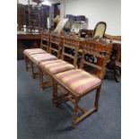 A set of four antique continental oak dining chairs with bergere seats