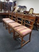 A set of four antique continental oak dining chairs with bergere seats