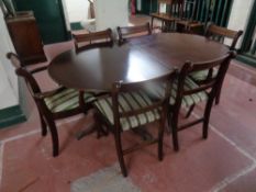 A Regency style inlaid mahogany twin pedestal dining table together with a set of six chairs,