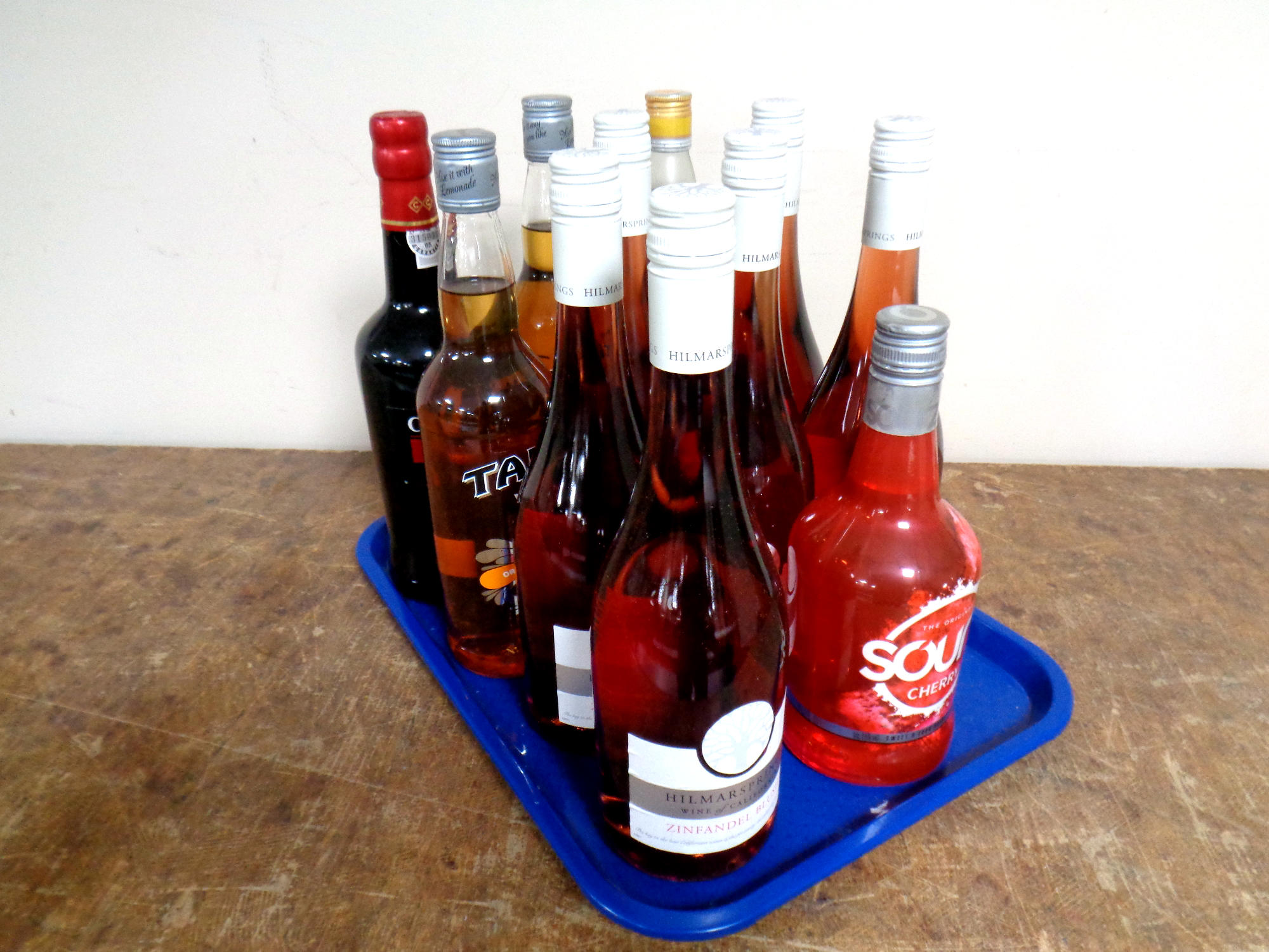 A tray containing eleven bottles of alcohol to include six bottles of Hilmar Springs Californian