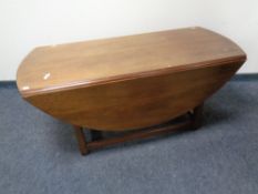 A drop leaf coffee table in a mahogany finish