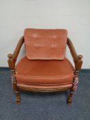 A beech framed tub armchair upholstered in a pink dralon