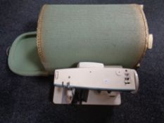 A Singer electric sewing machine with foot pedal together with a green loom linen box