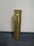 A brass ammunition shell casing,