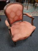 A carved beech wood salon armchair upholstered in a pink brocade fabric
