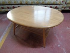 An Ercol solid elm and beech oval coffee table with undershelf