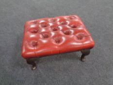 A red button leather Chesterfield footstool