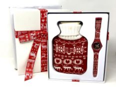 A Swatch Christmas 2013 wristwatch and hot water bottle in box.