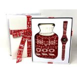 A Swatch Christmas 2013 wristwatch and hot water bottle in box.