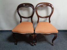 A pair of 19th century balloon back chairs on cabriole legs