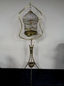 A Victorian brass bird cage on tripod stand made in Germany