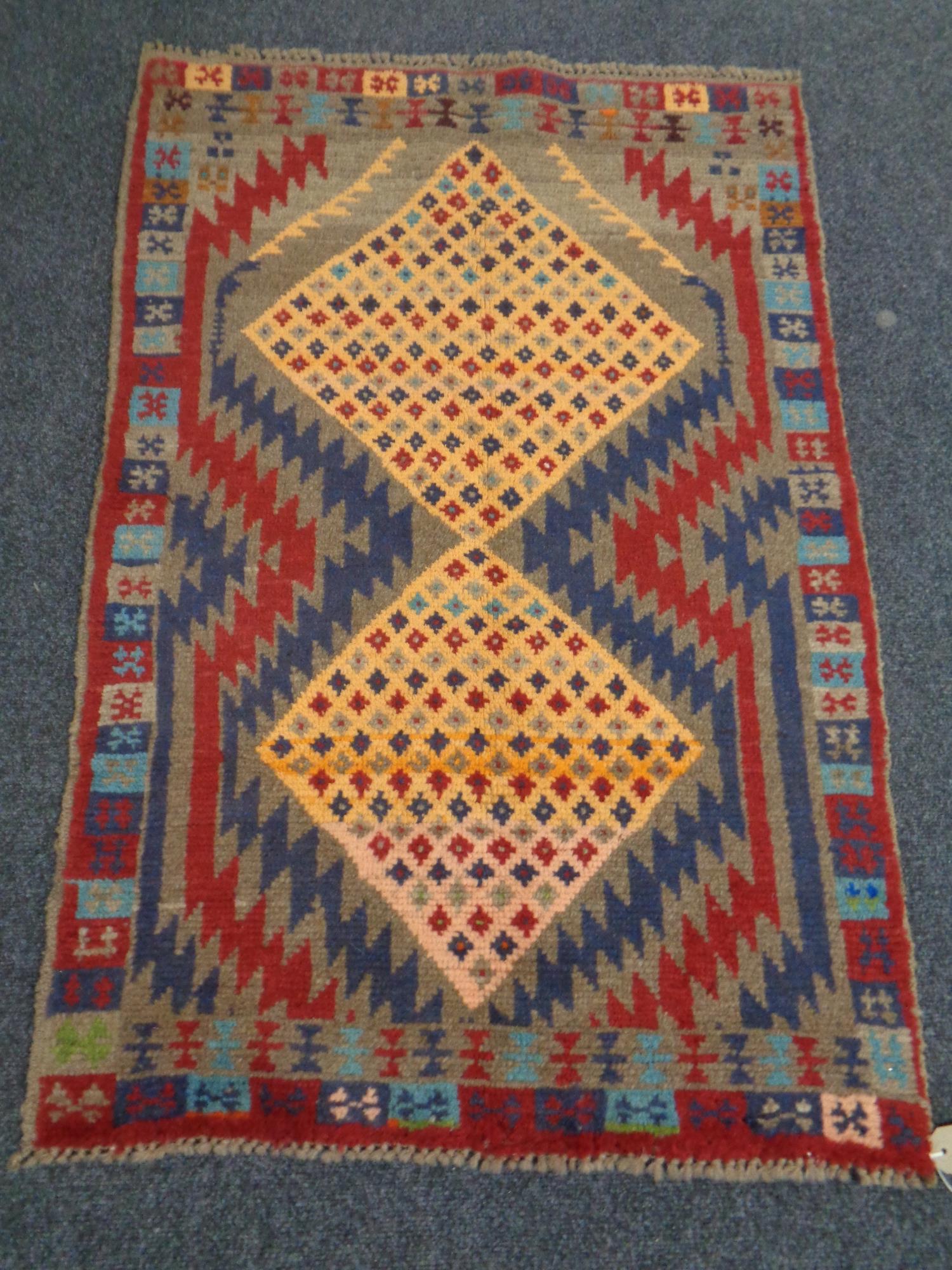 A Baluchi rug, 118cm by 77cm.