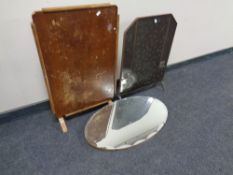 An Arts and Crafts copper fire screen together with a folding occasional table and an oval bevel
