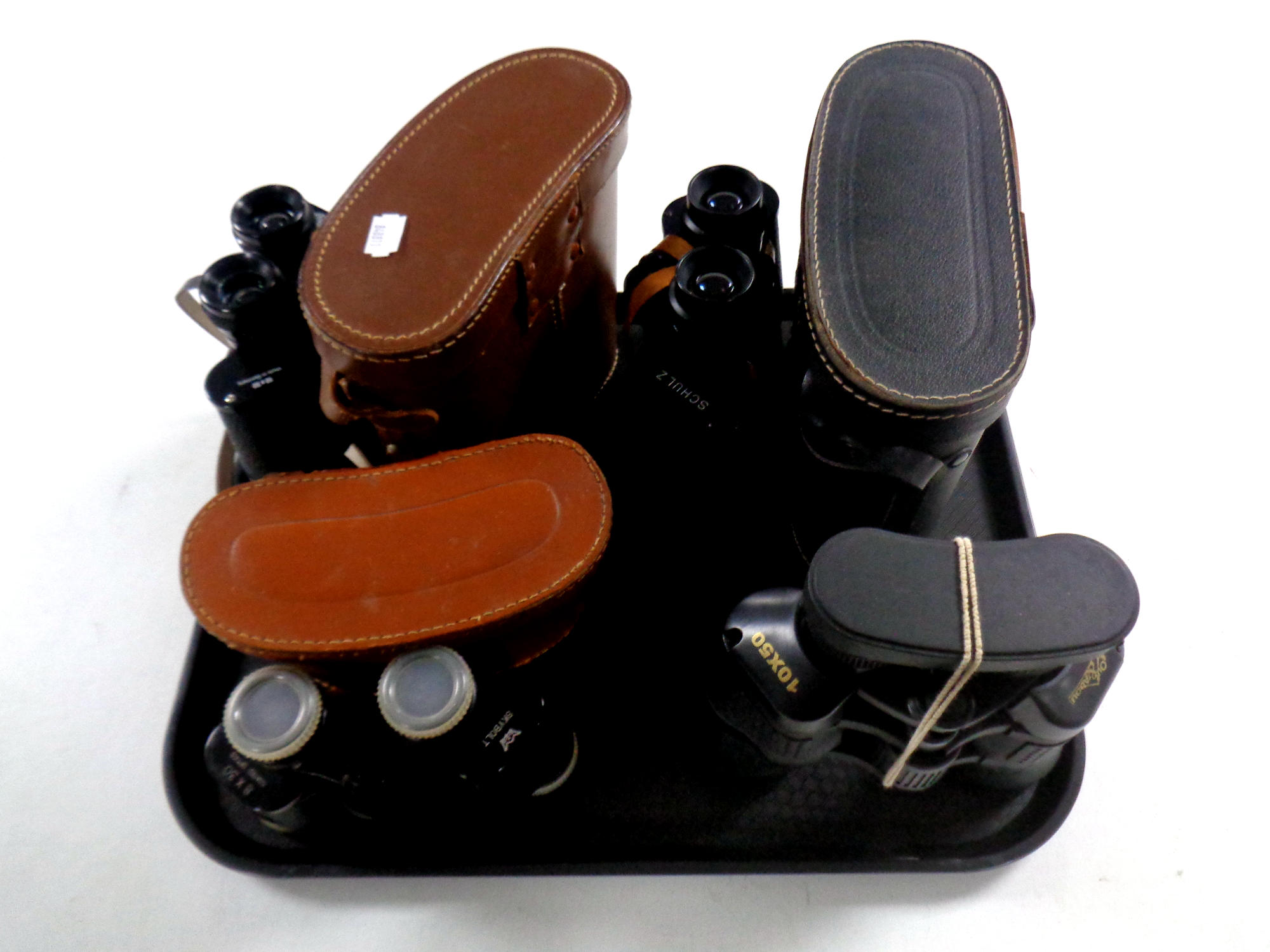 A tray containing three sets of cased field glasses to include Skybolt,