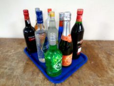 A tray containing nine bottles of alcohol to include Cockburn's Port (75cl),