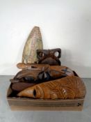 A box containing carved tribal tourist masks