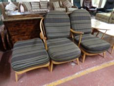 A pair of Ercol solid elm and beech armchairs with matching footstool (as found)