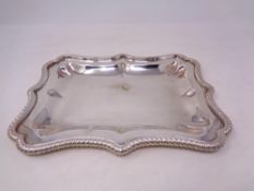 A heavy silver plated tray with scalloped edge, width 29 cm.