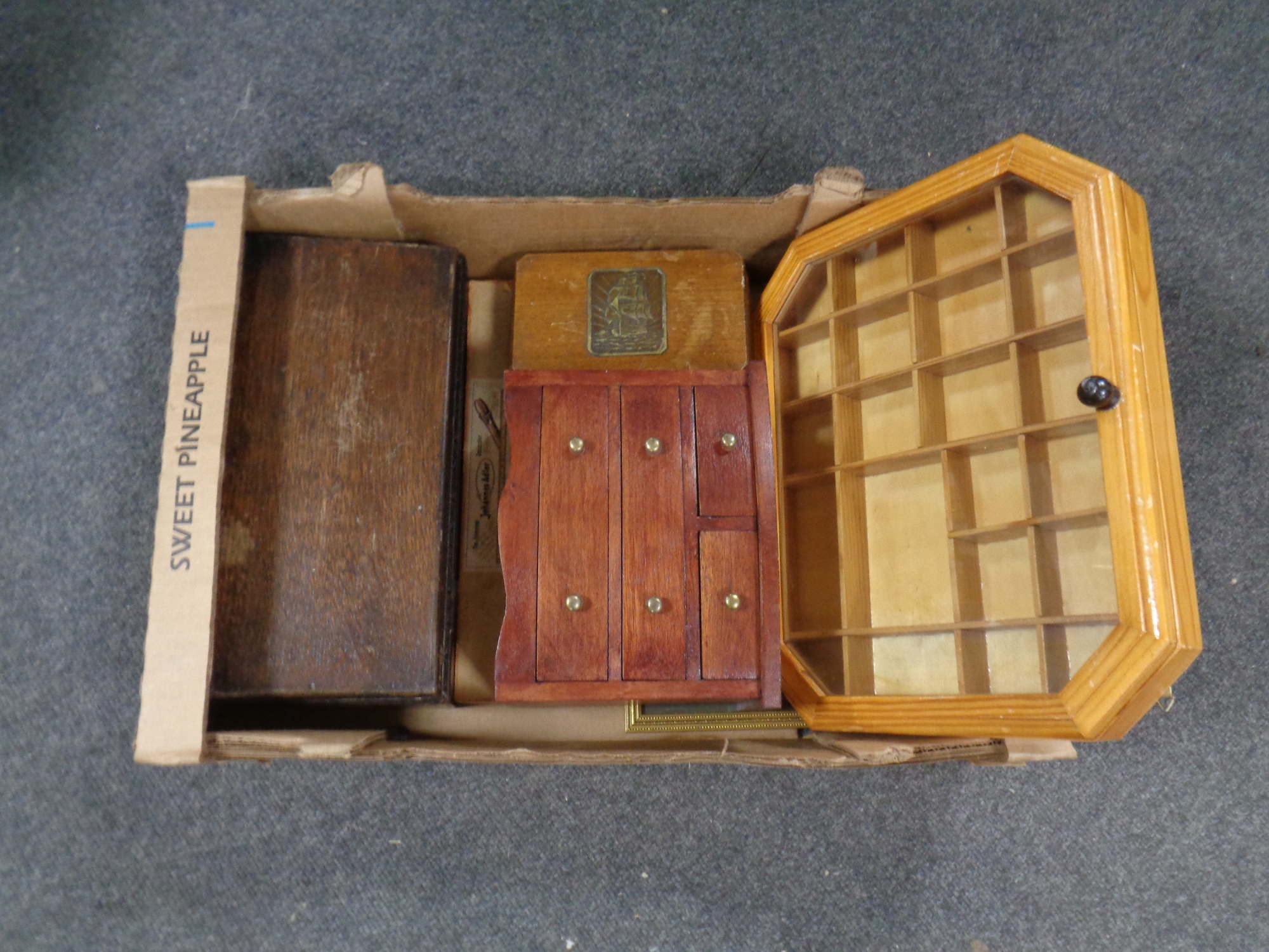 A box containing trinket boxes, miniature four drawer chest,