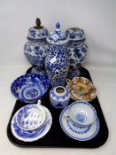 A tray containing early 20th century and later oriental wares to include blue and white teacups