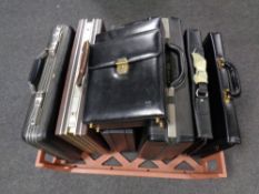 A crate containing a quantity of assorted briefcases and business bags