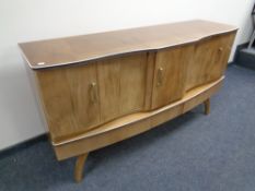 A mid 20th century walnut veneered cocktail sideboard