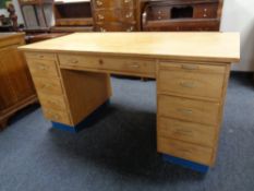 A mid 20th century Scandinavian twin pedestal desk fitted nine drawers and two slides
